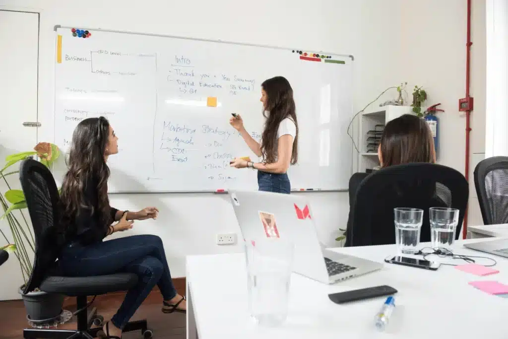 Team collaborating on a marketing strategy in a modern office setting.