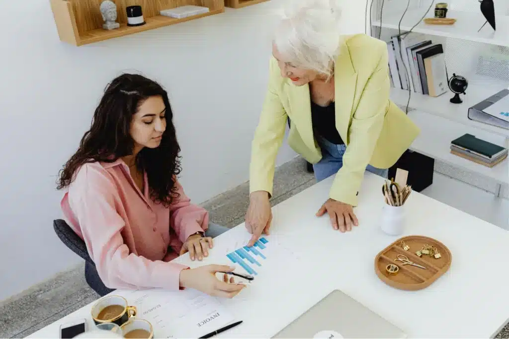 Older woman mentoring young professional in an office