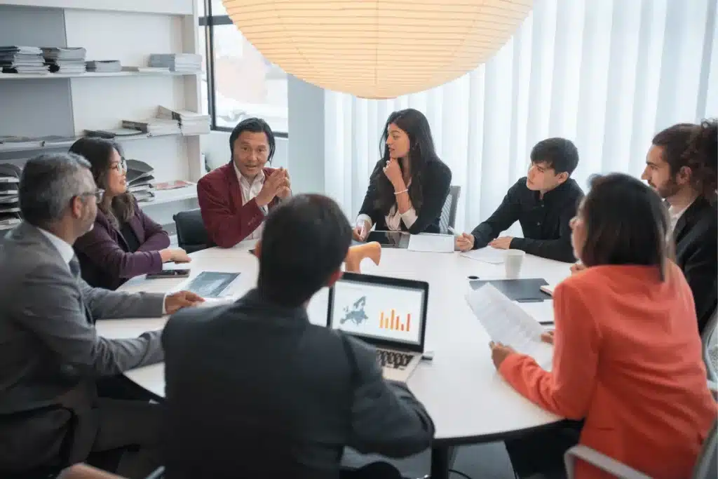 Business team in a meeting discussing strategy with charts and reports.