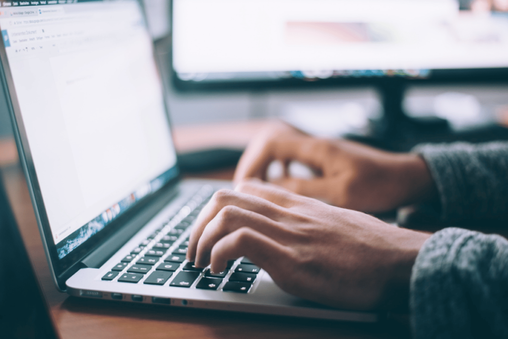 Focused on typing: A professional at work on a laptop.