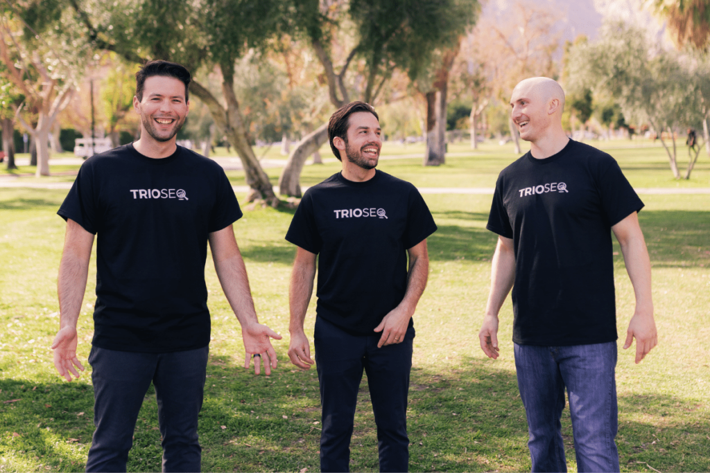 Cheerful outdoor photo of Nathan, Steven, and Connor in TRIOS® black t-shirts.