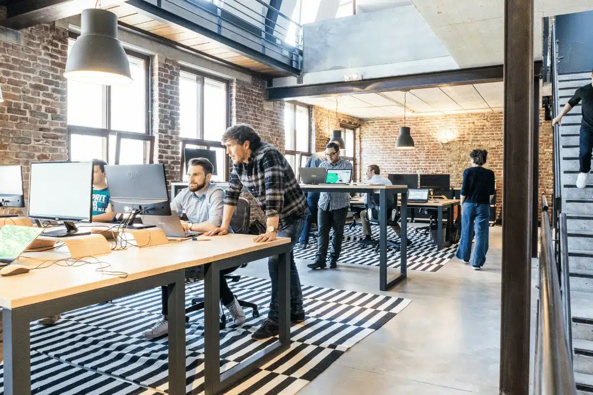 Open-plan office with a team of developers working at their desks.