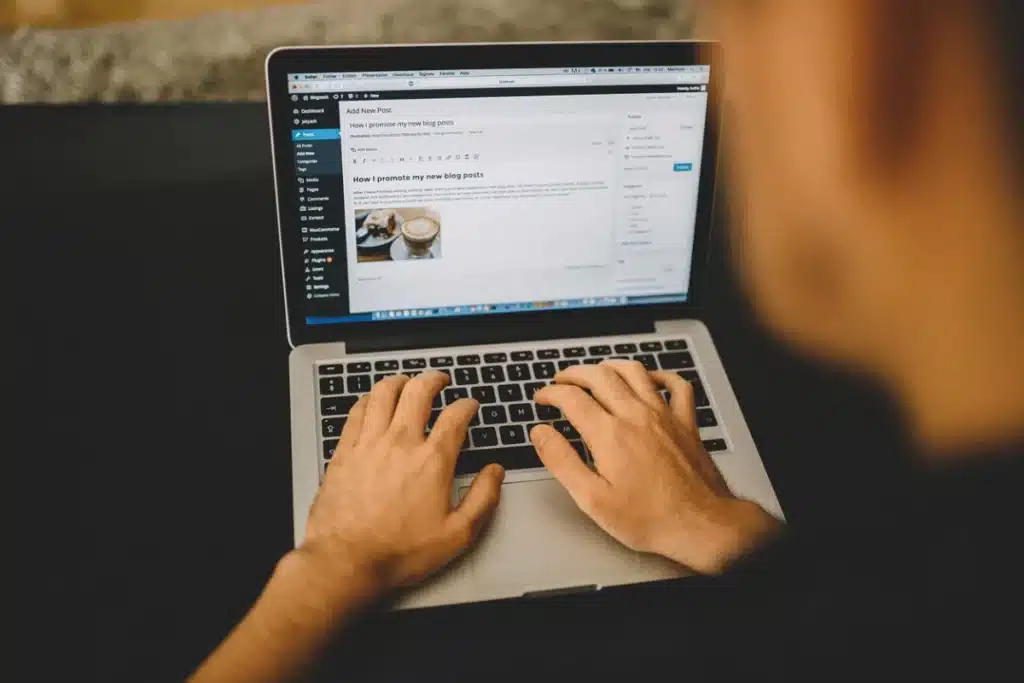 Creative workspace with a blogger editing a post on a laptop.